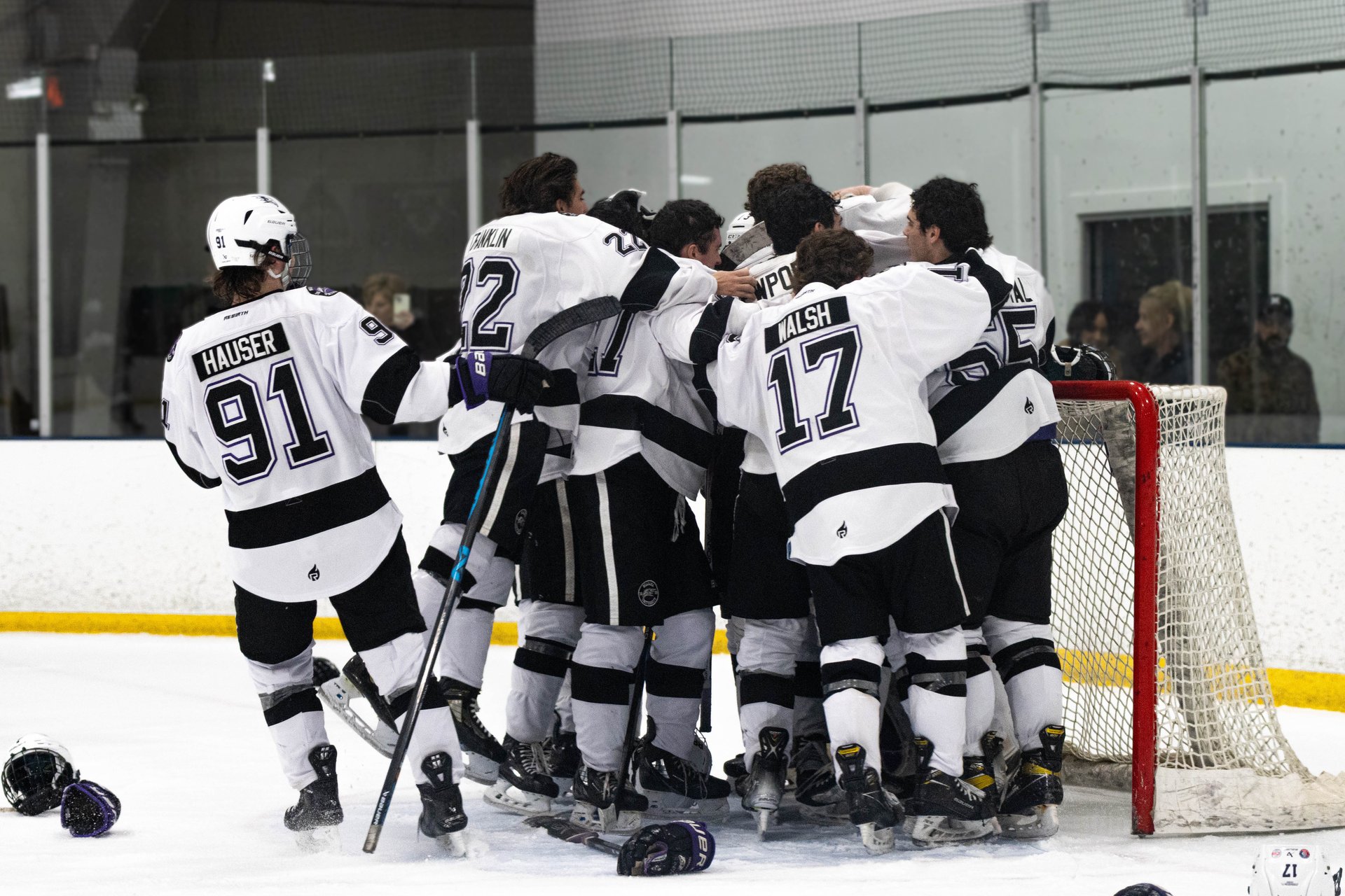 hockey team celebrating championship win on the ice