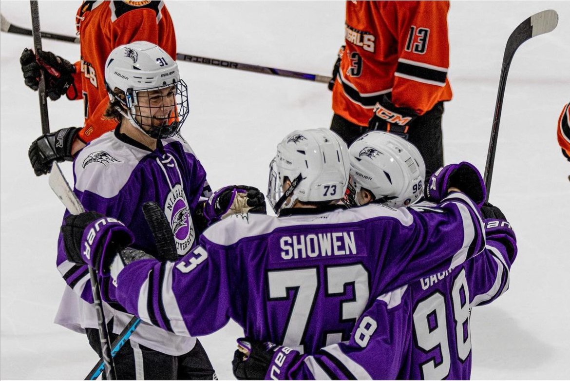 Derwin Hauser celebrating a goal with two teammates