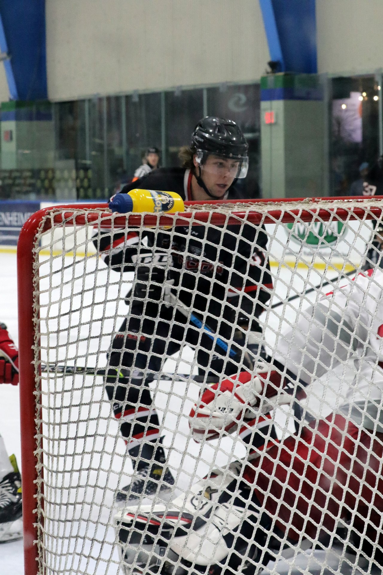 Derwin Hauser battling in front of the net to score a goal