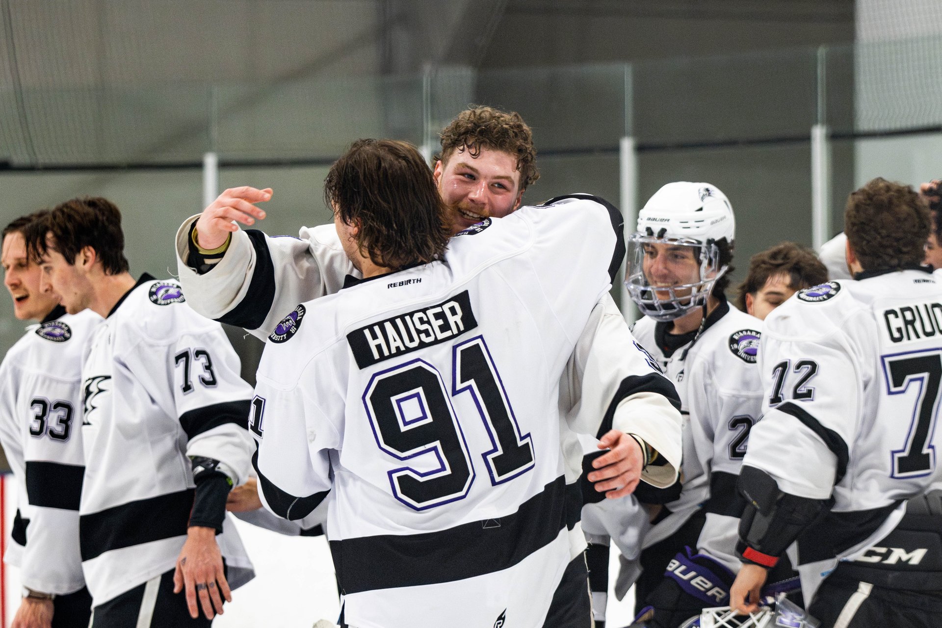 Derwin Hauser hugging teammate on ice after championship win