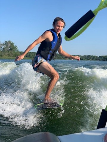 Derwin Hauser wakesurfing behind a boat