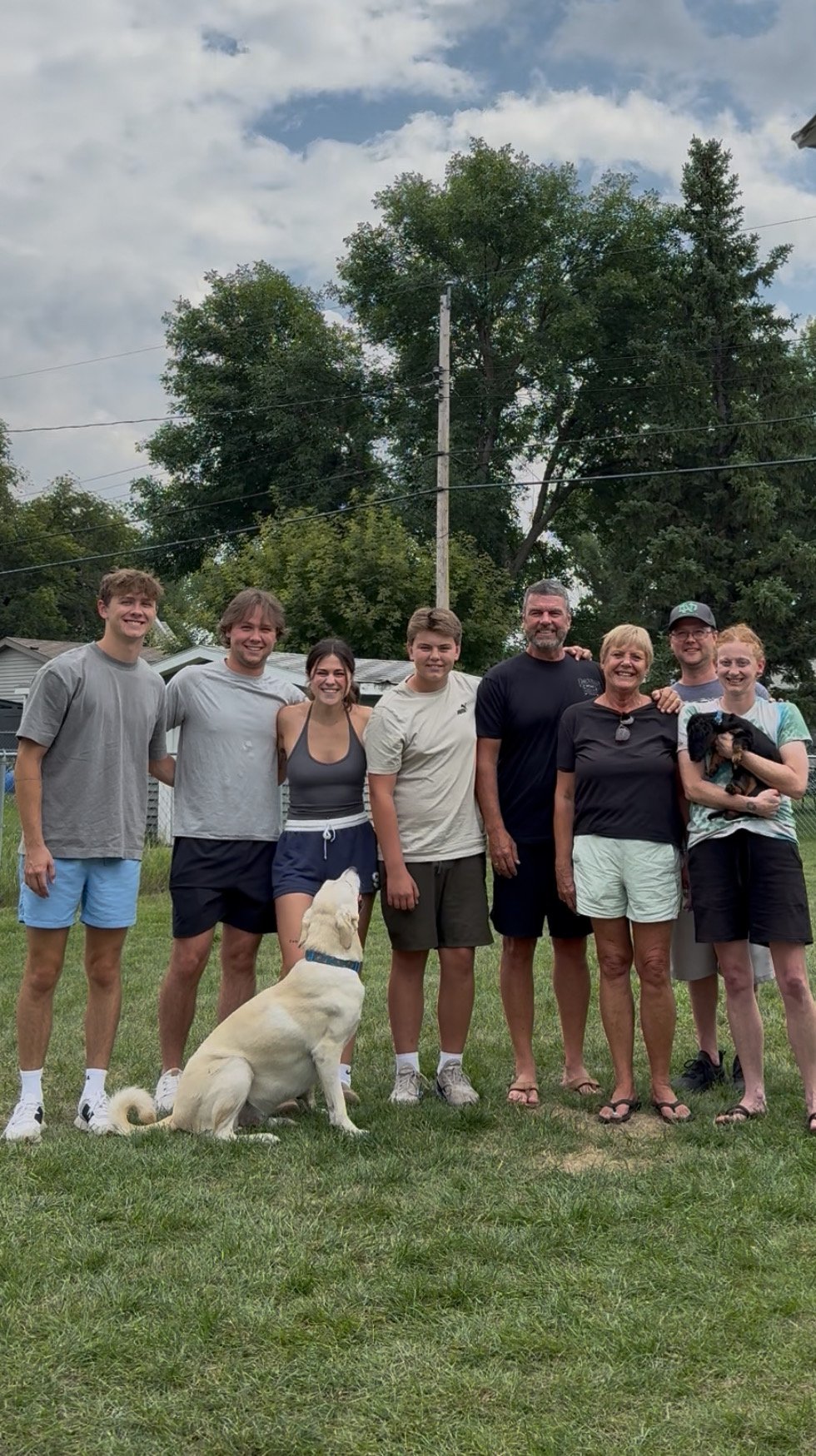 Derwin Hauser with his family in the backyard